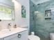 Bathroom featuring a modern glass-enclosed shower with blue subway tile and decorative accents at 713 Macon Pl, Raleigh, NC 27609
