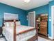 A cozy bedroom has a decorative wood bed frame and a vintage display cabinet at 713 Macon Pl, Raleigh, NC 27609