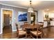 Dining room with hardwood floors and a view into the kitchen with stainless steel appliances at 713 Macon Pl, Raleigh, NC 27609