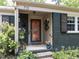 Inviting covered front porch with brick accents and decorative welcome decor at 713 Macon Pl, Raleigh, NC 27609