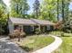 Attractive exterior featuring a winding walkway leading to a charming single-story home at 713 Macon Pl, Raleigh, NC 27609