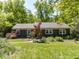 Charming single-story home featuring a well-maintained lawn and lush landscaping at 713 Macon Pl, Raleigh, NC 27609