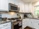 Stylish kitchen featuring stainless steel appliances, granite countertops, and ample cabinet space at 713 Macon Pl, Raleigh, NC 27609