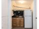 Finished basement kitchenette with a mini-refrigerator and built in sink and storage at 713 Macon Pl, Raleigh, NC 27609