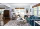 Cozy living room with a plush blue sofa, decorative rug, and ample natural light at 713 Macon Pl, Raleigh, NC 27609