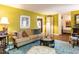 Well-lit living room with a comfortable sofa, decorative accents, and a view into the entryway at 713 Macon Pl, Raleigh, NC 27609