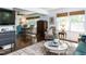 Bright living room featuring hardwood floors, stylish furniture, and large windows at 713 Macon Pl, Raleigh, NC 27609