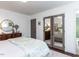Bright main bedroom showcasing a mirrored closet and a glimpse of the en-suite bathroom at 713 Macon Pl, Raleigh, NC 27609