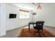 Finished basement office with industrial lighting, kitchenette, and a large sunny window at 713 Macon Pl, Raleigh, NC 27609