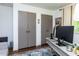 A home office has two gray storage closets, a large rug, and a desk with a computer at 713 Macon Pl, Raleigh, NC 27609