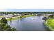 Aerial view of a scenic pond with a fountain surrounded by lush greenery and buildings at 72 S Grey Abbey Dr, Clayton, NC 27527