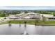 Aerial view of a scenic pond with a fountain, greenery, buildings, and a commercial area at 72 S Grey Abbey Dr, Clayton, NC 27527