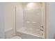Clean bathroom featuring a white toilet and a shower-tub combination with a handheld shower at 72 S Grey Abbey Dr, Clayton, NC 27527