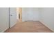 Bright bedroom featuring neutral carpet, white walls, and a convenient closet space at 72 S Grey Abbey Dr, Clayton, NC 27527