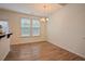 This light-filled dining room features wood floors, a chandelier, and access to the backyard at 72 S Grey Abbey Dr, Clayton, NC 27527