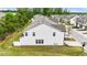 Exterior view of the home featuring new vinyl siding, green grass, and side entry windows at 72 S Grey Abbey Dr, Clayton, NC 27527