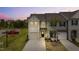 Charming two-story townhome featuring a garage, well-manicured lawn, and inviting entryway at 72 S Grey Abbey Dr, Clayton, NC 27527