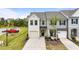 Charming townhome featuring a single-car garage, neutral siding, and a well-maintained front lawn at 72 S Grey Abbey Dr, Clayton, NC 27527