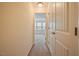 Bright hallway leading to a bedroom with neutral walls and carpet at 72 S Grey Abbey Dr, Clayton, NC 27527