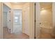 Hallway with a view into a bathroom and bedroom, tiled floors, and natural light at 72 S Grey Abbey Dr, Clayton, NC 27527