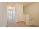 Upstairs hallway with neutral carpet and paint, access to bedrooms and additional storage at 72 S Grey Abbey Dr, Clayton, NC 27527