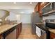 This bright and modern kitchen features granite countertops, stainless steel appliances, and wood-look flooring at 72 S Grey Abbey Dr, Clayton, NC 27527