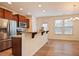Bright kitchen features a breakfast bar, stainless steel appliances, and beautiful wood floors and cabinetry at 72 S Grey Abbey Dr, Clayton, NC 27527
