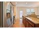 Well-equipped kitchen showcasing stainless steel appliances, granite countertops, and wood-look flooring at 72 S Grey Abbey Dr, Clayton, NC 27527