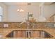 Close up of a kitchen island with a stainless steel sink, granite countertops, and modern faucet at 72 S Grey Abbey Dr, Clayton, NC 27527