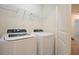 Modern laundry room featuring a washer, dryer, and wire shelving at 72 S Grey Abbey Dr, Clayton, NC 27527