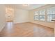 Bright living area boasting wood-look flooring, large windows, and neutral wall color at 72 S Grey Abbey Dr, Clayton, NC 27527