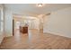 Open living space with wood-look floors, staircase and a view of the kitchen and dining area at 72 S Grey Abbey Dr, Clayton, NC 27527
