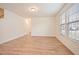Spacious living area with wood-look flooring, natural light, and a view of the hallway at 72 S Grey Abbey Dr, Clayton, NC 27527