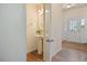 This half bath features a pedestal sink, wood floors, and is located off the entry foyer at 72 S Grey Abbey Dr, Clayton, NC 27527