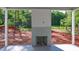 Covered back porch with gray brick fireplace and tile floor at 7301 Wexford Woods Ln, Wake Forest, NC 27587