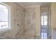 Marble-tiled shower with built-in niche and window at 7301 Wexford Woods Ln, Wake Forest, NC 27587
