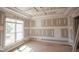 Unfinished bedroom with paneled ceilings, a large window, and craftsman style trim at 7301 Wexford Woods Ln, Wake Forest, NC 27587