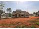 New construction two-story home featuring a gray exterior, a welcoming porch, and a spacious yard at 7301 Wexford Woods Ln, Wake Forest, NC 27587