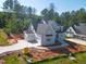 Beautiful new construction home with gray exterior, attached garage, and a lush, wooded backyard at 7301 Wexford Woods Ln, Wake Forest, NC 27587