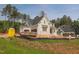 New construction two-story home with light gray brick, white trim, and black roof at 7301 Wexford Woods Ln, Wake Forest, NC 27587