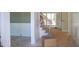 Bright hallway with hardwood floors, wainscoting, a staircase with wood handrail and iron balusters at 7301 Wexford Woods Ln, Wake Forest, NC 27587