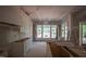 Spacious unfinished kitchen with white cabinets, an island, and large windows at 7301 Wexford Woods Ln, Wake Forest, NC 27587