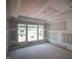 Bright living room featuring large windows and tray ceiling, ready for personalized finishing touches at 7301 Wexford Woods Ln, Wake Forest, NC 27587