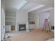 Spacious living room with fireplace, custom built-in shelving, and large windows for natural light at 7301 Wexford Woods Ln, Wake Forest, NC 27587
