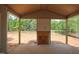Covered patio with natural wood ceiling overlooks a wooded yard and offers a relaxing outdoor living space at 7301 Wexford Woods Ln, Wake Forest, NC 27587