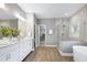 Modern bathroom with double vanity, soaking tub, and glass-enclosed shower at 7510 Latteri Ct, Raleigh, NC 27613