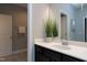 Bathroom vanity with dark cabinets, white countertop, decorative mirror, and tiled floor at 7510 Latteri Ct, Raleigh, NC 27613