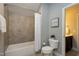 Well-maintained bathroom with a tub/shower, neutral tile, and modern fixtures for a comfortable and clean space at 7510 Latteri Ct, Raleigh, NC 27613