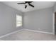 Neutral bedroom with carpet, a ceiling fan, a window with blinds, and access to a closet at 7510 Latteri Ct, Raleigh, NC 27613