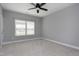 Neutral bedroom featuring plush carpeting, ample natural light, and a ceiling fan at 7510 Latteri Ct, Raleigh, NC 27613